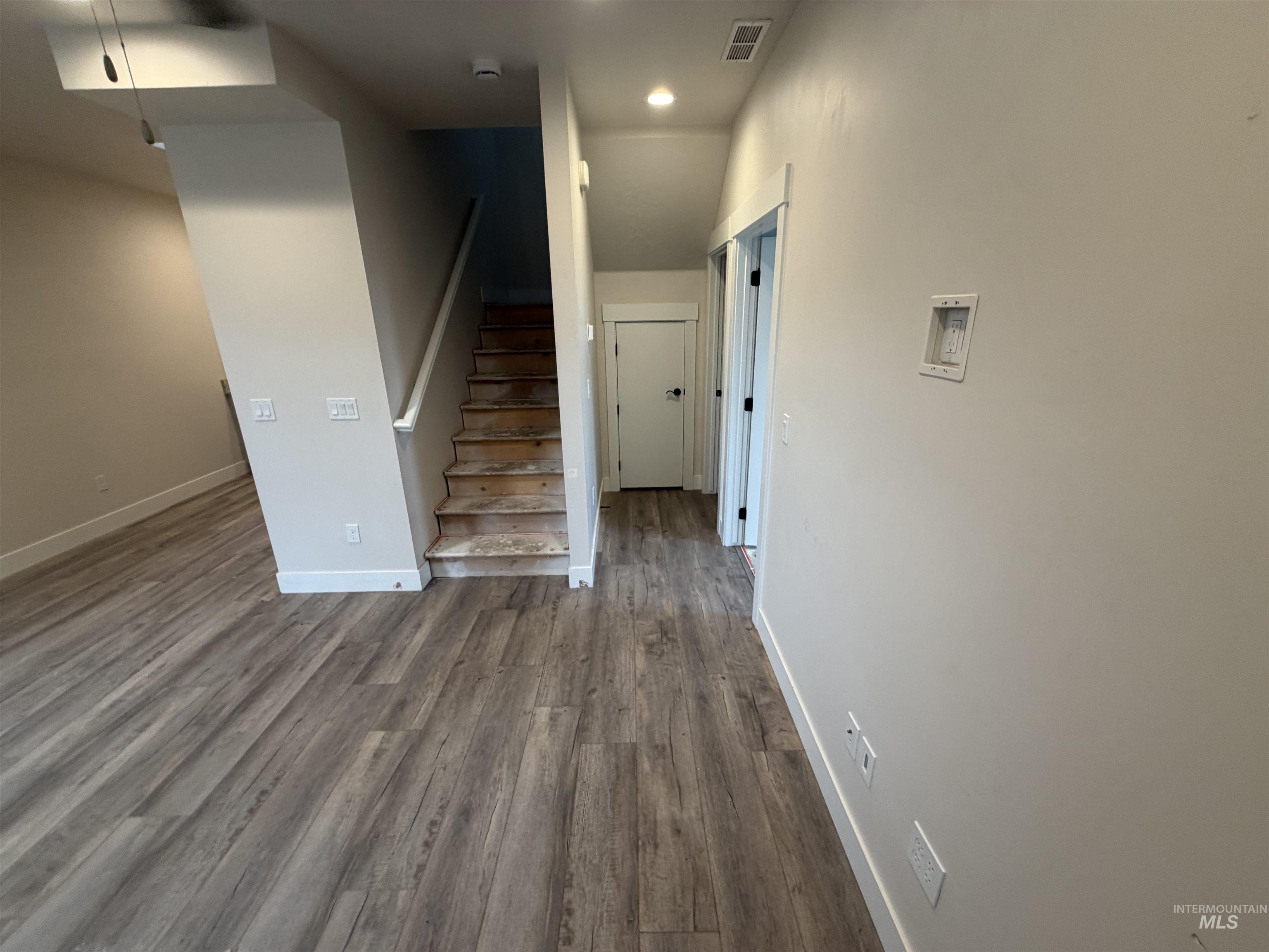 1475 North Bluffs Ridge Lane Boise, ID 83704 - Photo 4 of 13 Spacious room featuring wood-finish flooring, recessed lighting, and a modern ceiling fan (backside of dining room and side of living room - main floor)