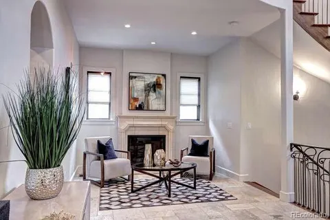 a living room with furniture potted plant and a fireplace
