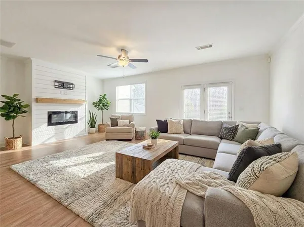 an empty room with a window and a fan