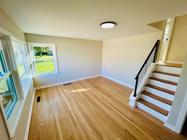 768 North Rohde Avenue Hillside, IL 60162 - Photo 2 of 20 a view of an empty room with wooden floor and a window