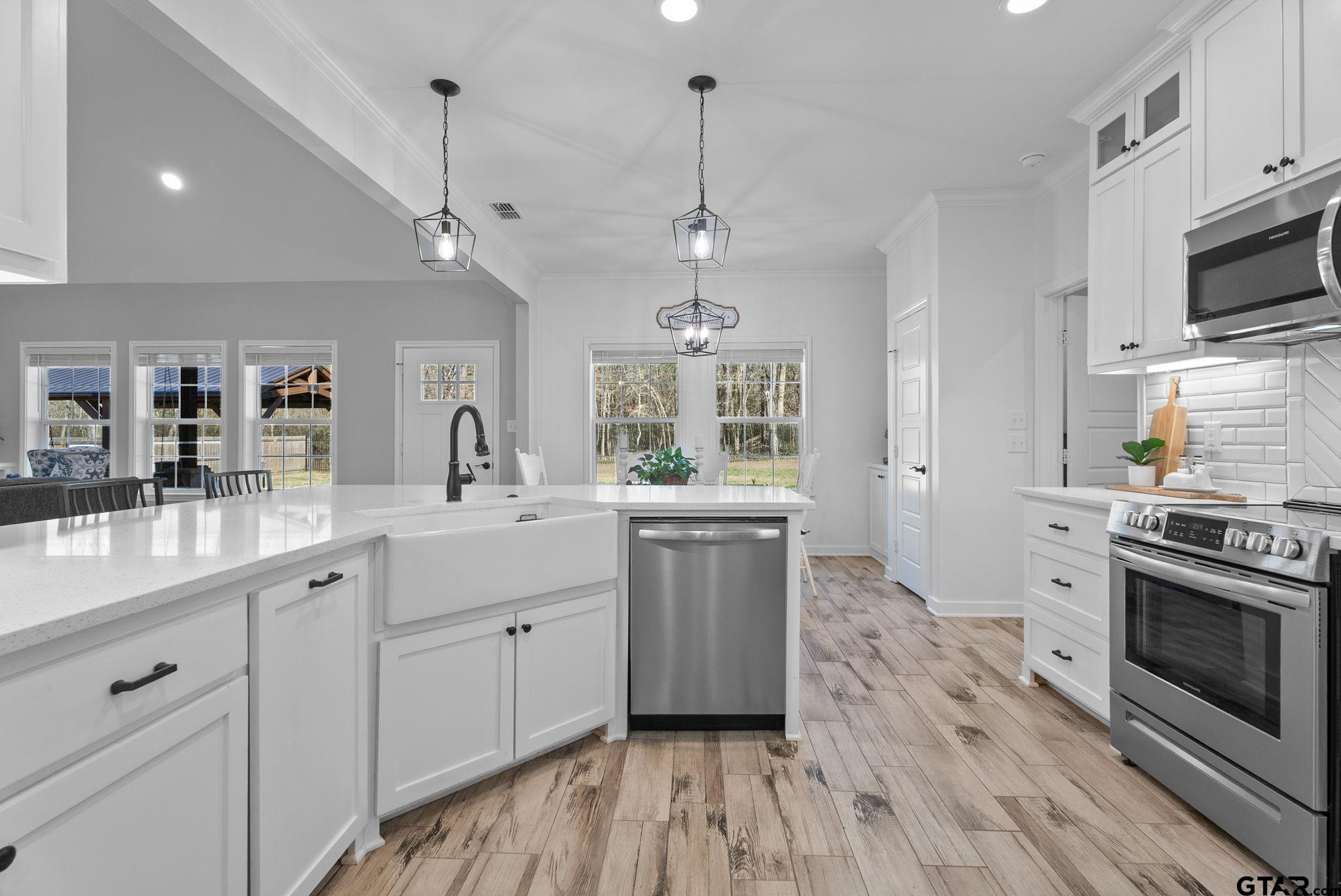 14543 Fallow Lane Tyler, TX 75706 - Photo 12 of 32 a kitchen with white cabinets stainless steel appliances and sink