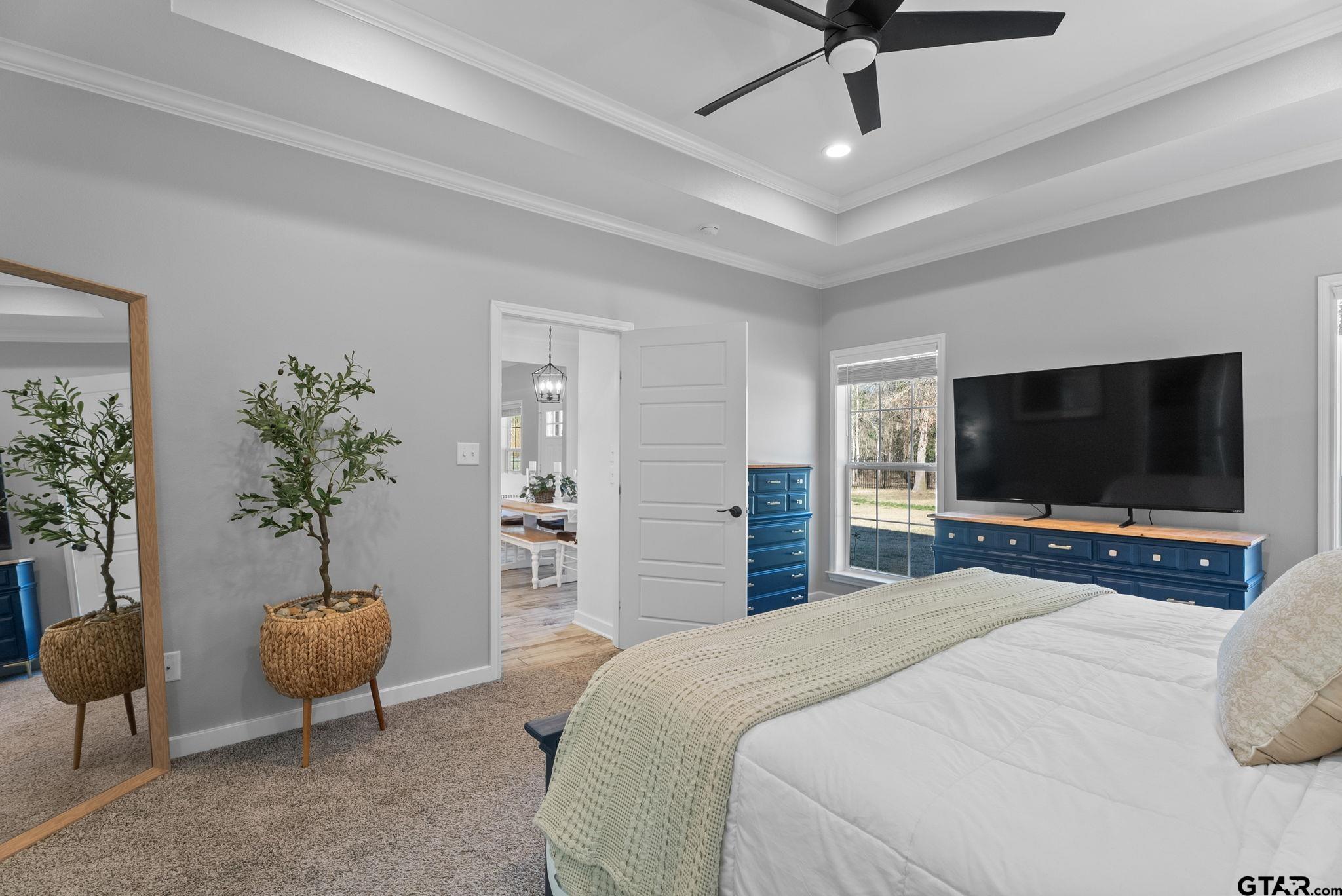 14543 Fallow Lane Tyler, TX 75706 - Photo 14 of 32 a bedroom with a bed and a flat screen tv