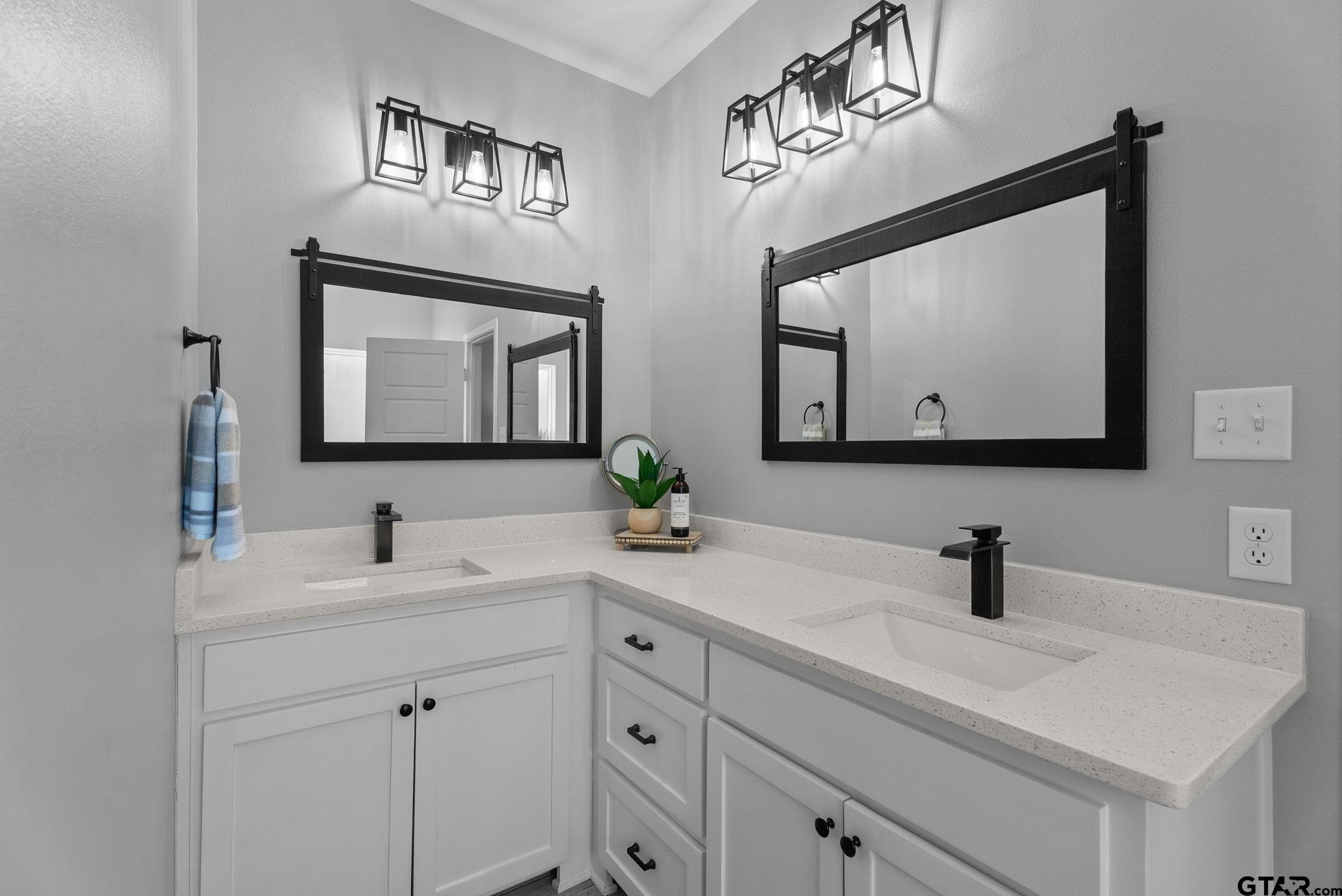 14543 Fallow Lane Tyler, TX 75706 - Photo 15 of 32 a bathroom with double vanity sinks and a mirror