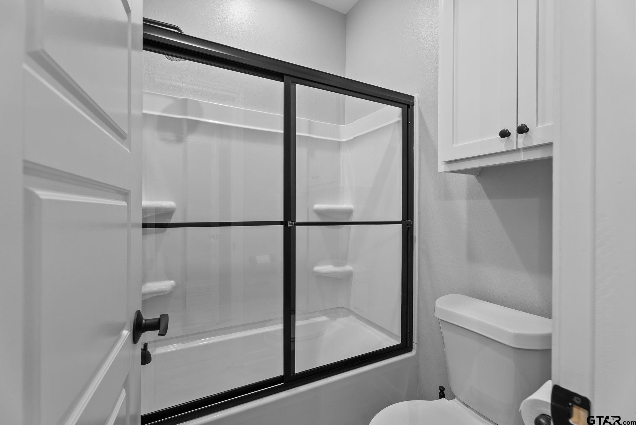 14543 Fallow Lane Tyler, TX 75706 - Photo 20 of 32 a bathroom with a shower a toilet and a sink