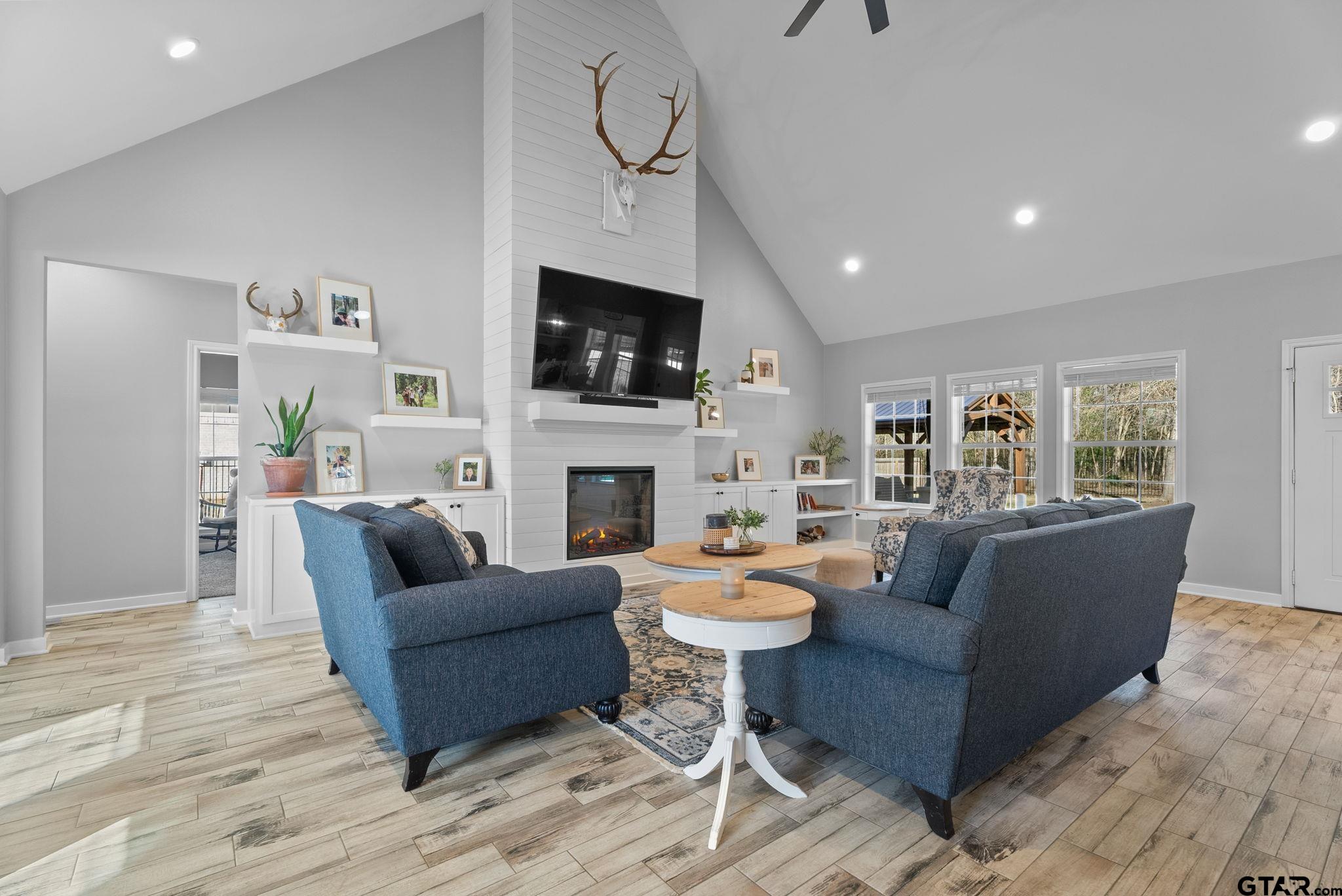 14543 Fallow Lane Tyler, TX 75706 - Photo 4 of 32 a living room with furniture a fireplace and a flat screen tv