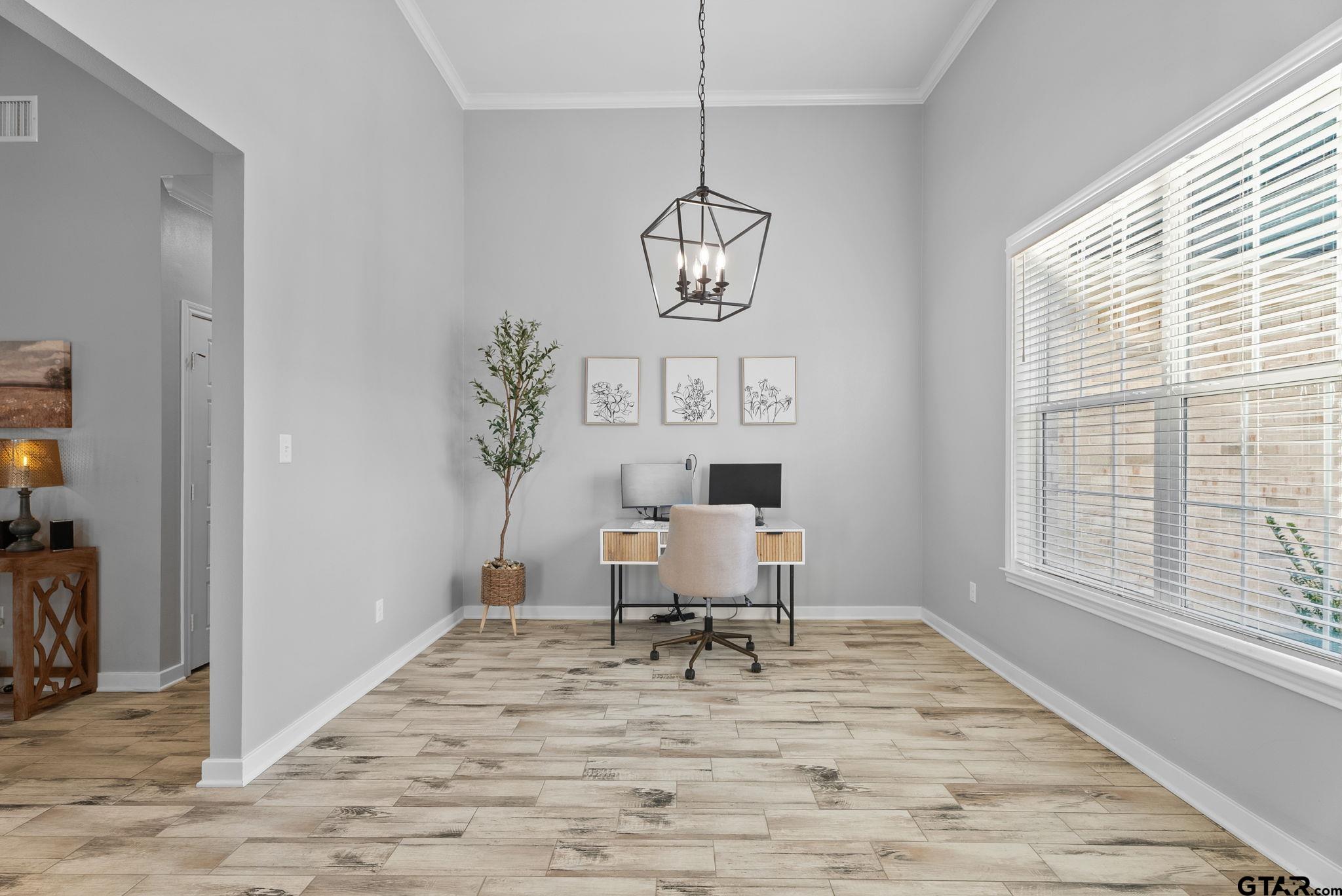 14543 Fallow Lane Tyler, TX 75706 - Photo 7 of 32 a view of a room with wooden floor table and chairs