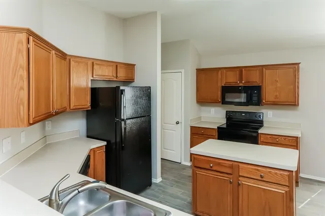 a kitchen with a refrigerator and a microwave