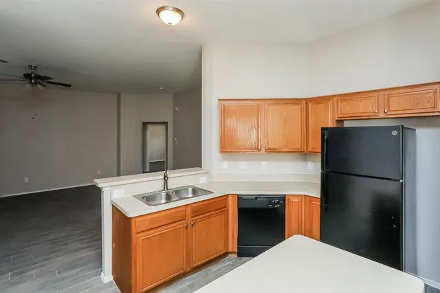 a kitchen with a refrigerator sink and cabinets