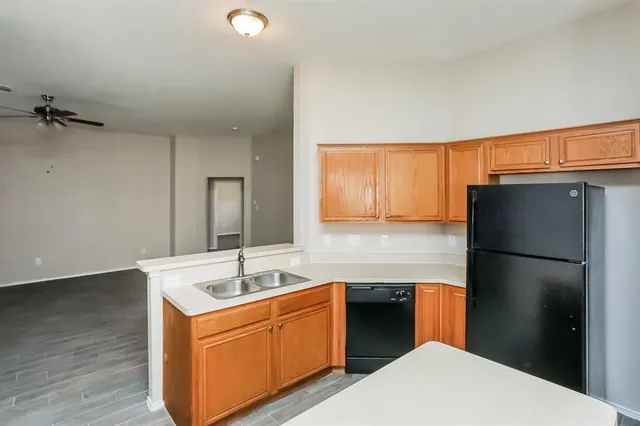 a kitchen with a refrigerator sink and cabinets