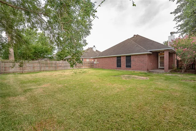 a house view with swimming pool in front of it