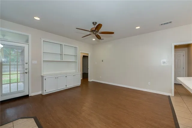 an empty room with closet and windows