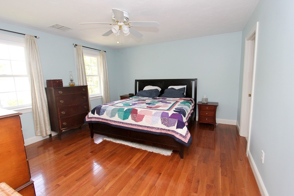 7 Middle Road Amesbury, MA 01913 - Photo 11 of 25 a bedroom with a bed and wooden floor
