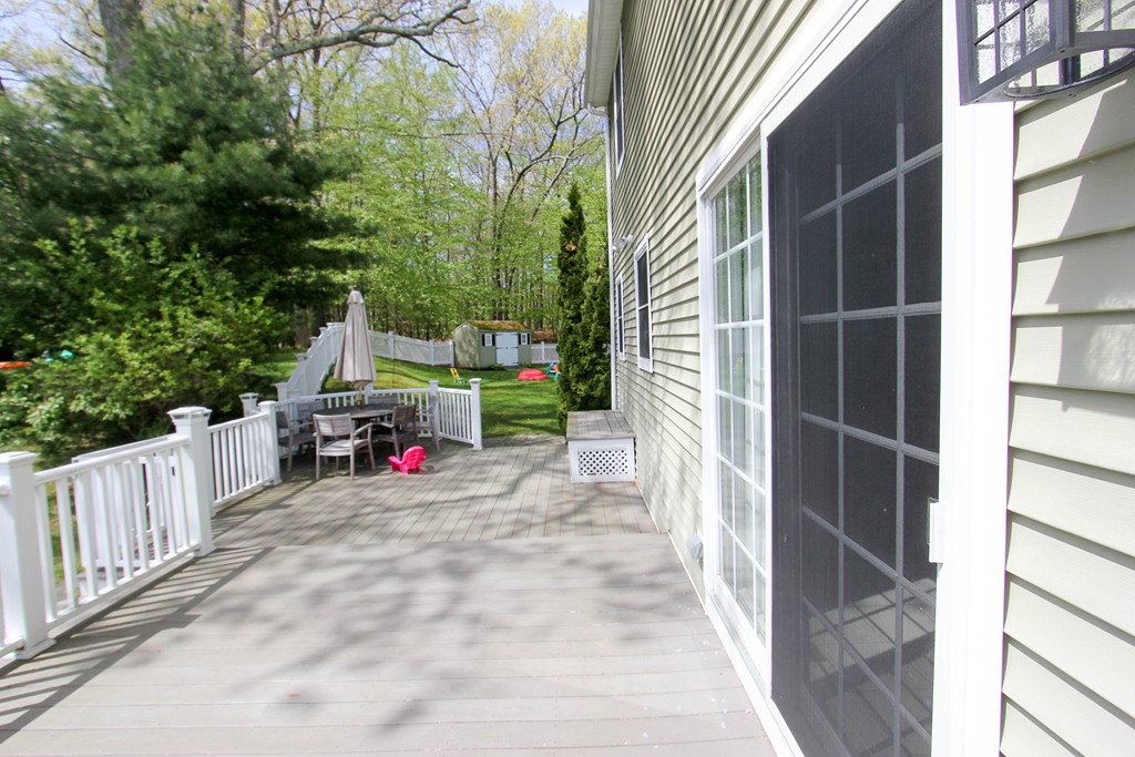 7 Middle Road Amesbury, MA 01913 - Photo 21 of 25 a view of a house with a porch and wooden fence