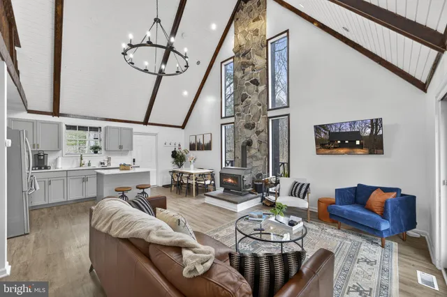 a bedroom with a bed window and a chandelier