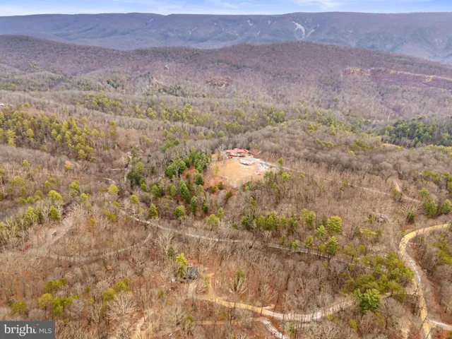 a front view of a house with a yard covered in snow