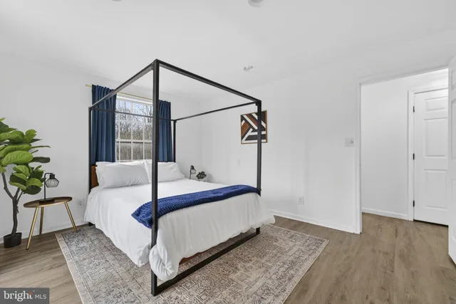 a view of a roof deck with couches and wooden floor