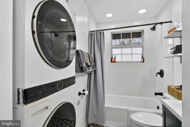 a view of a backyard with a small deck and a chairs