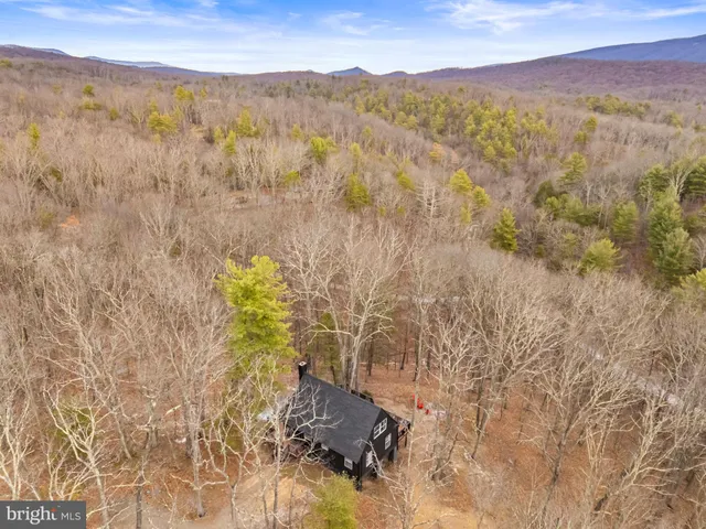a kitchen with stainless steel appliances a refrigerator a sink a stove and white cabinets