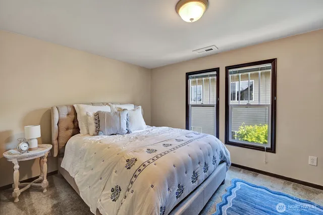 a bedroom with a bed and window