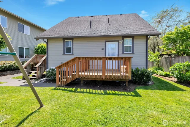 a view of a house with a swimming pool and a yard