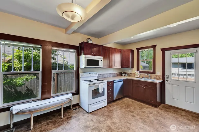 a kitchen with lots of counter top space and stainless steel appliances