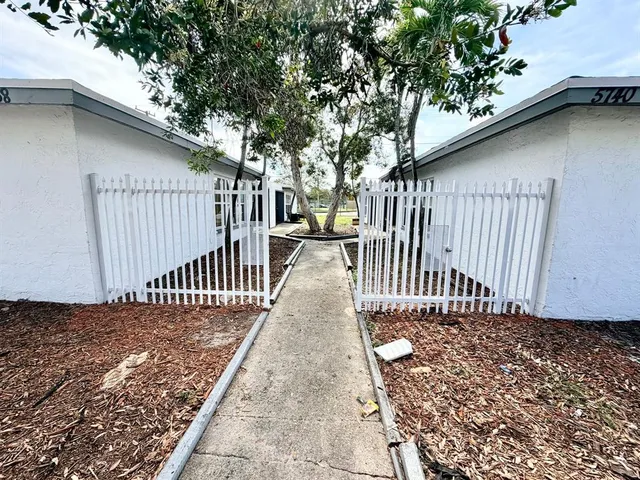 a porch with a table and chairs
