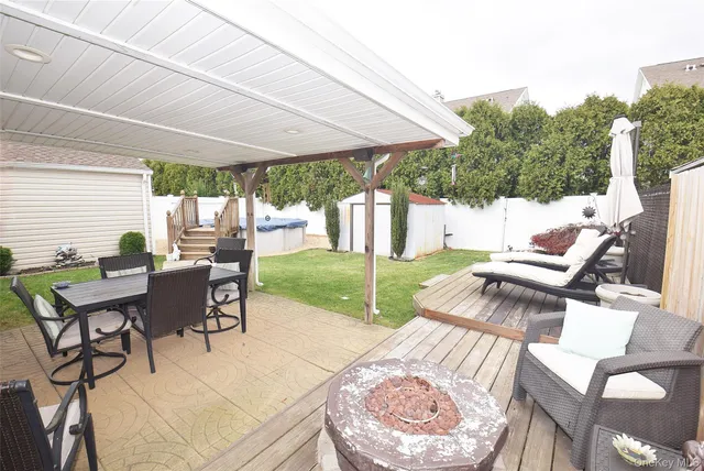 a view of a patio with a dining table and chairs with a backyard