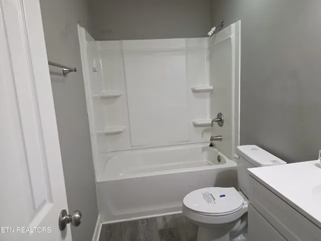 a bathroom with a sink toilet tub and shower