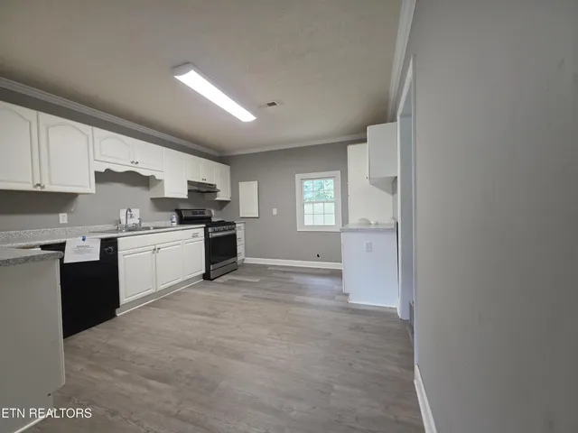 a kitchen with a sink a window and stainless steel appliances