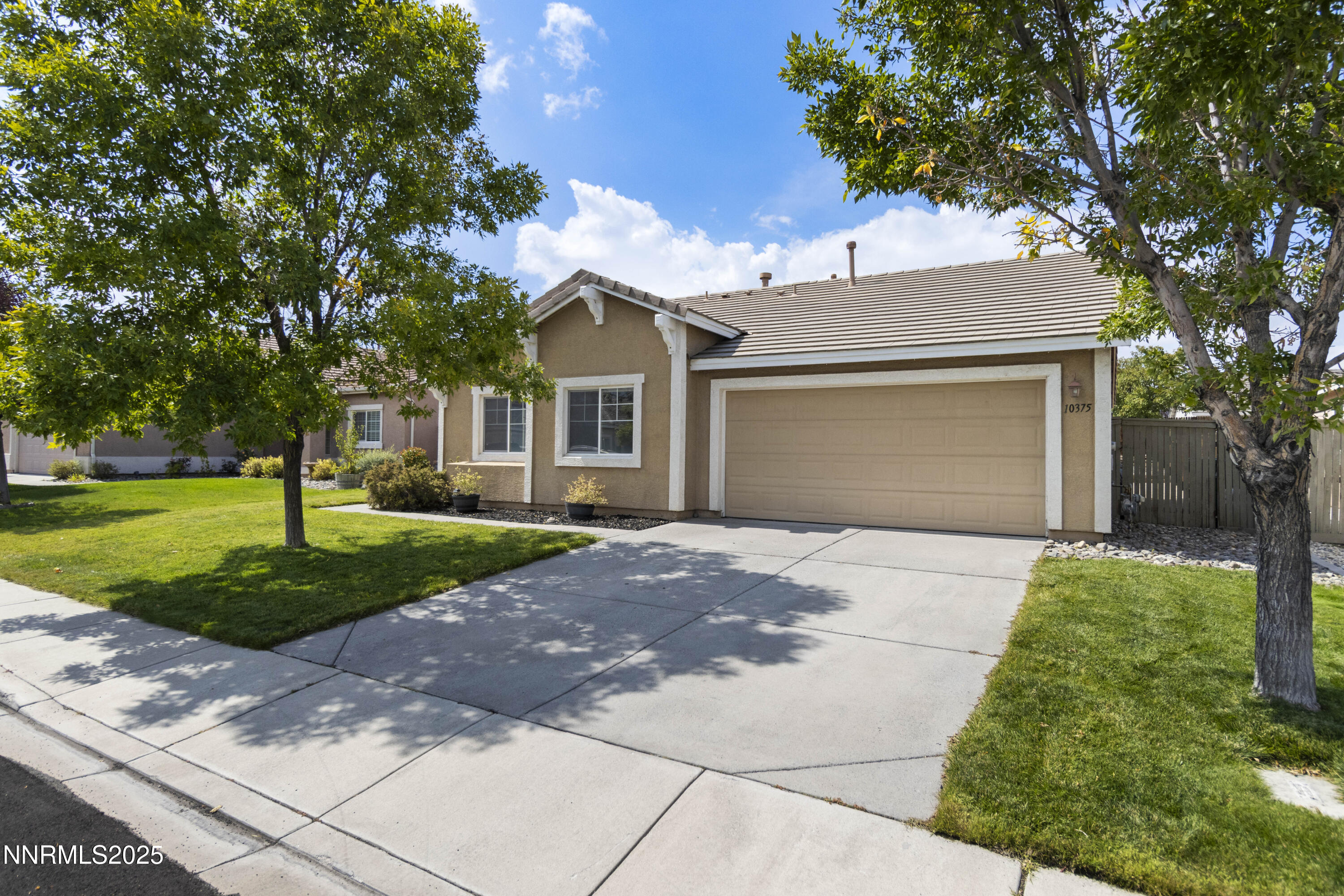 10375 Rosemount Drive Reno, NV 89521 - Photo 1 of 29 a front view of a house with a yard and garage