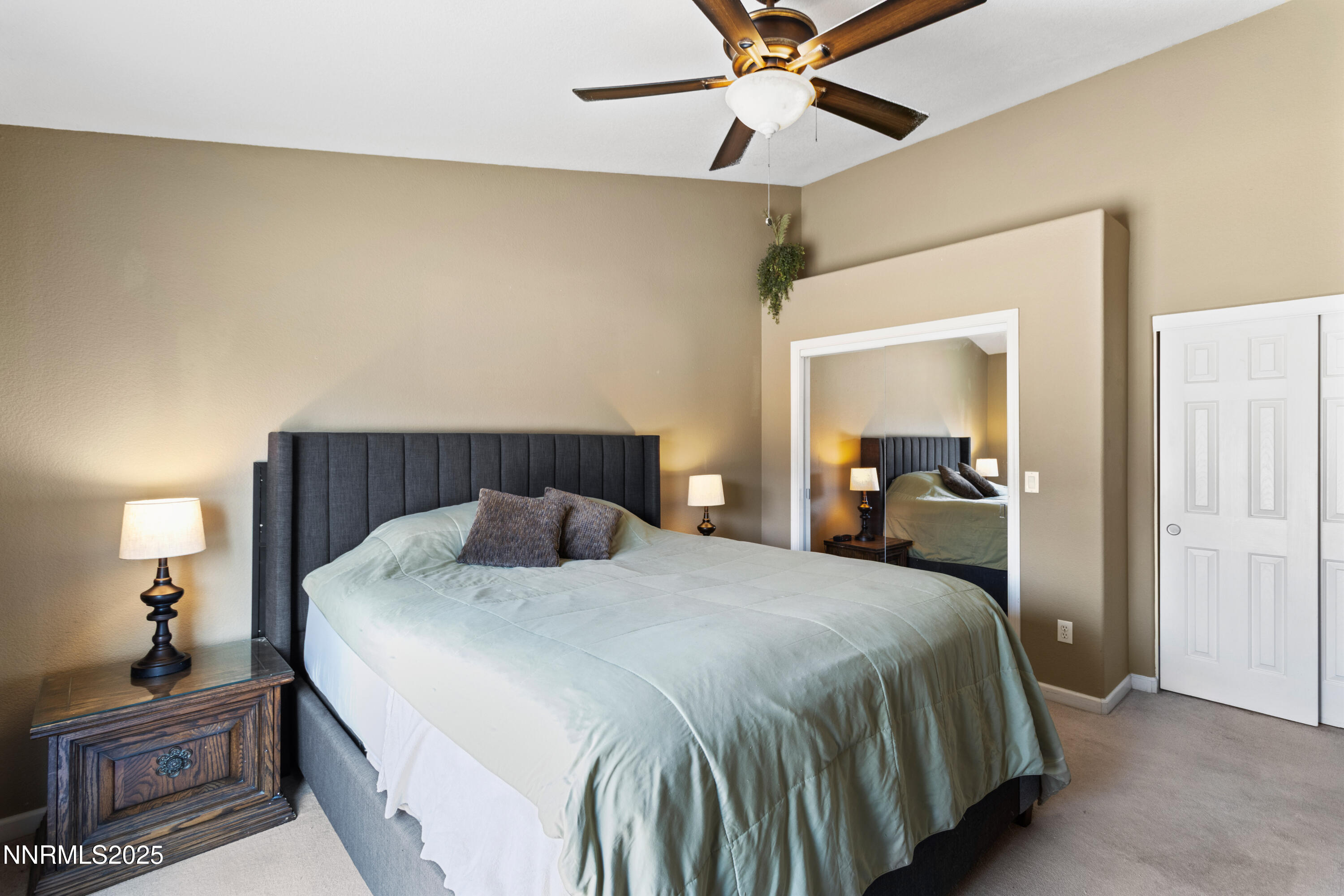10375 Rosemount Drive Reno, NV 89521 - Photo 11 of 29 a bedroom with a bed and a chandelier