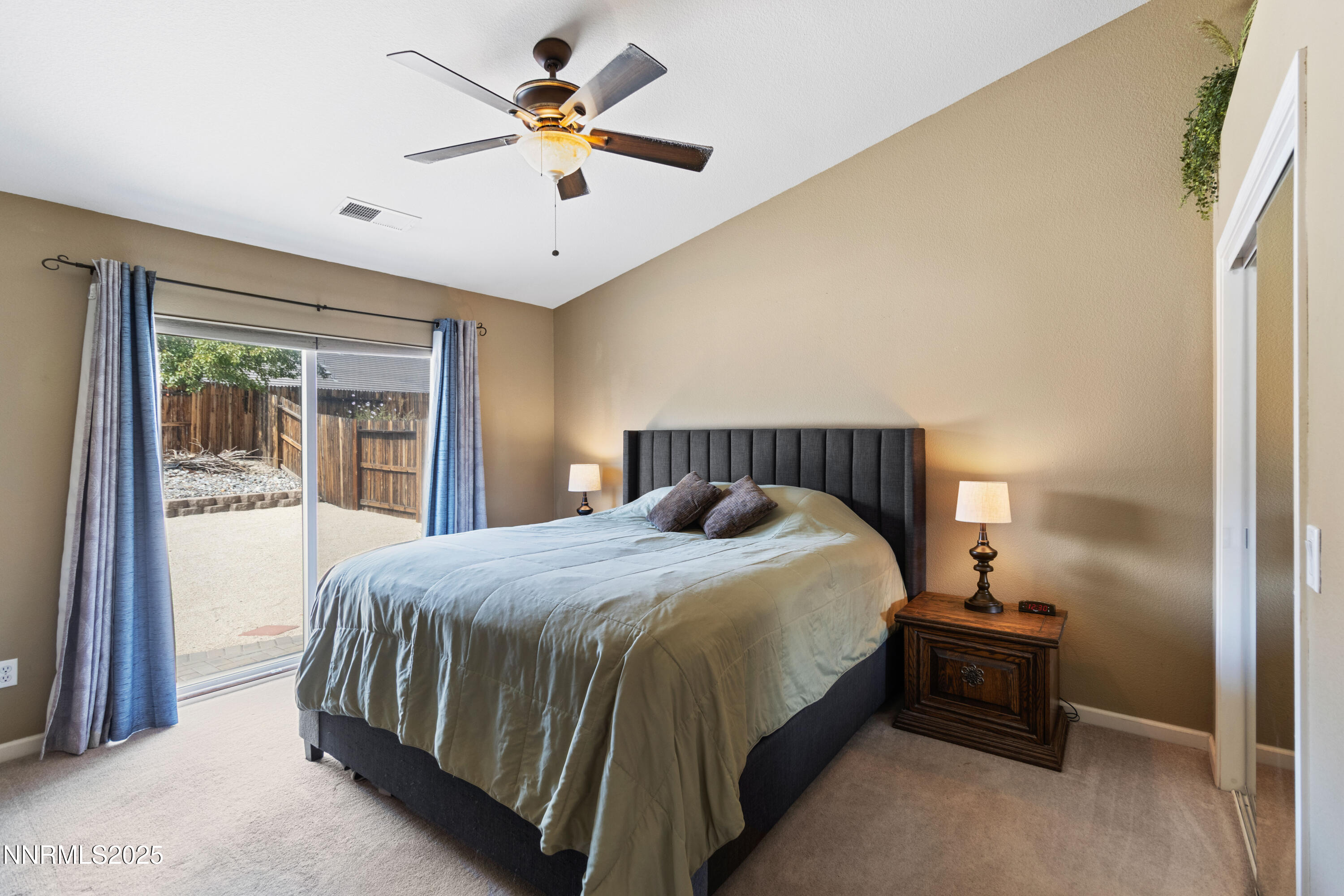 10375 Rosemount Drive Reno, NV 89521 - Photo 12 of 29 a bedroom with a bed and a chandelier