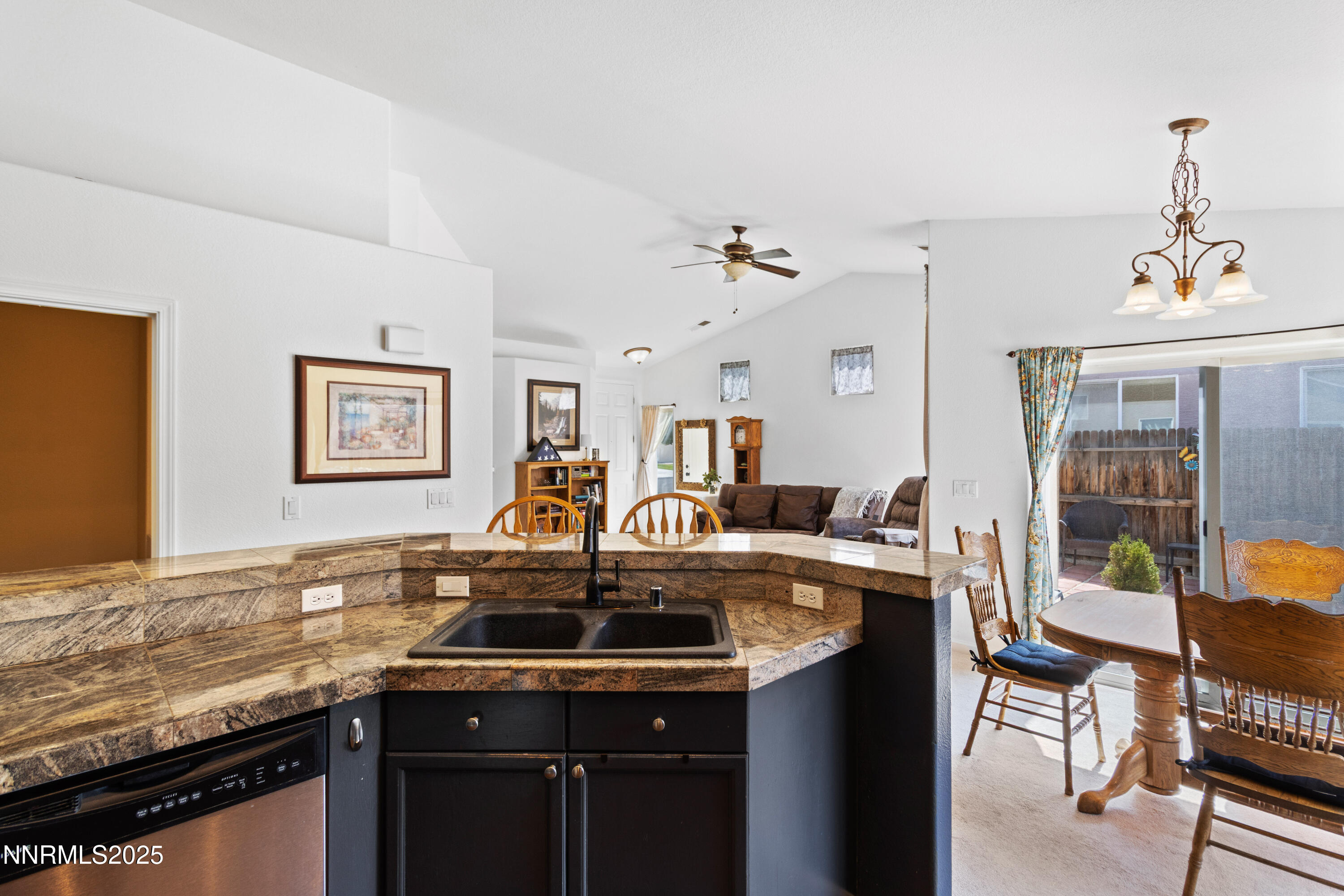 10375 Rosemount Drive Reno, NV 89521 - Photo 13 of 29 a kitchen with a sink a stove and chairs
