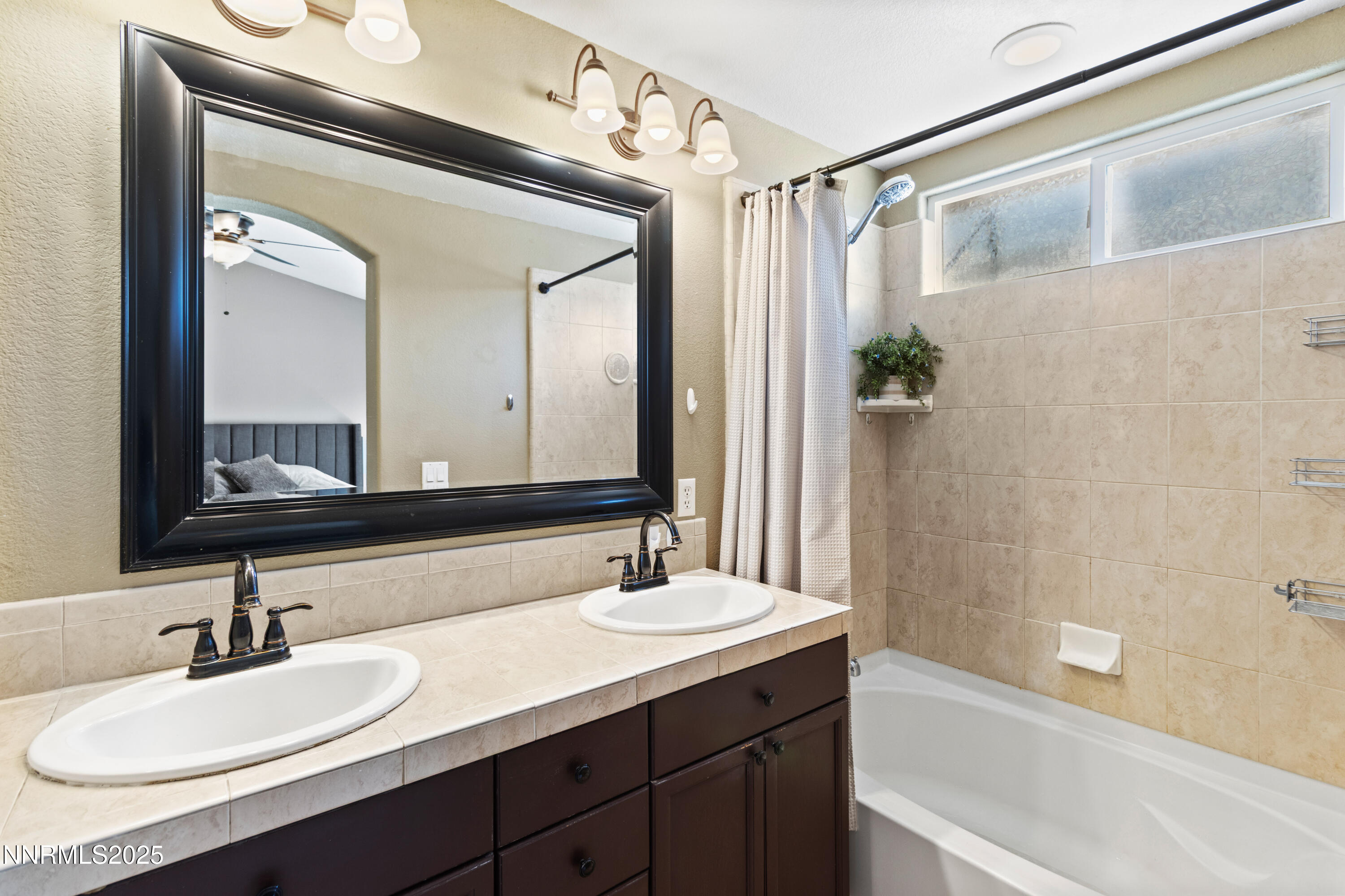 10375 Rosemount Drive Reno, NV 89521 - Photo 17 of 29 a bathroom with a granite countertop sink and a mirror