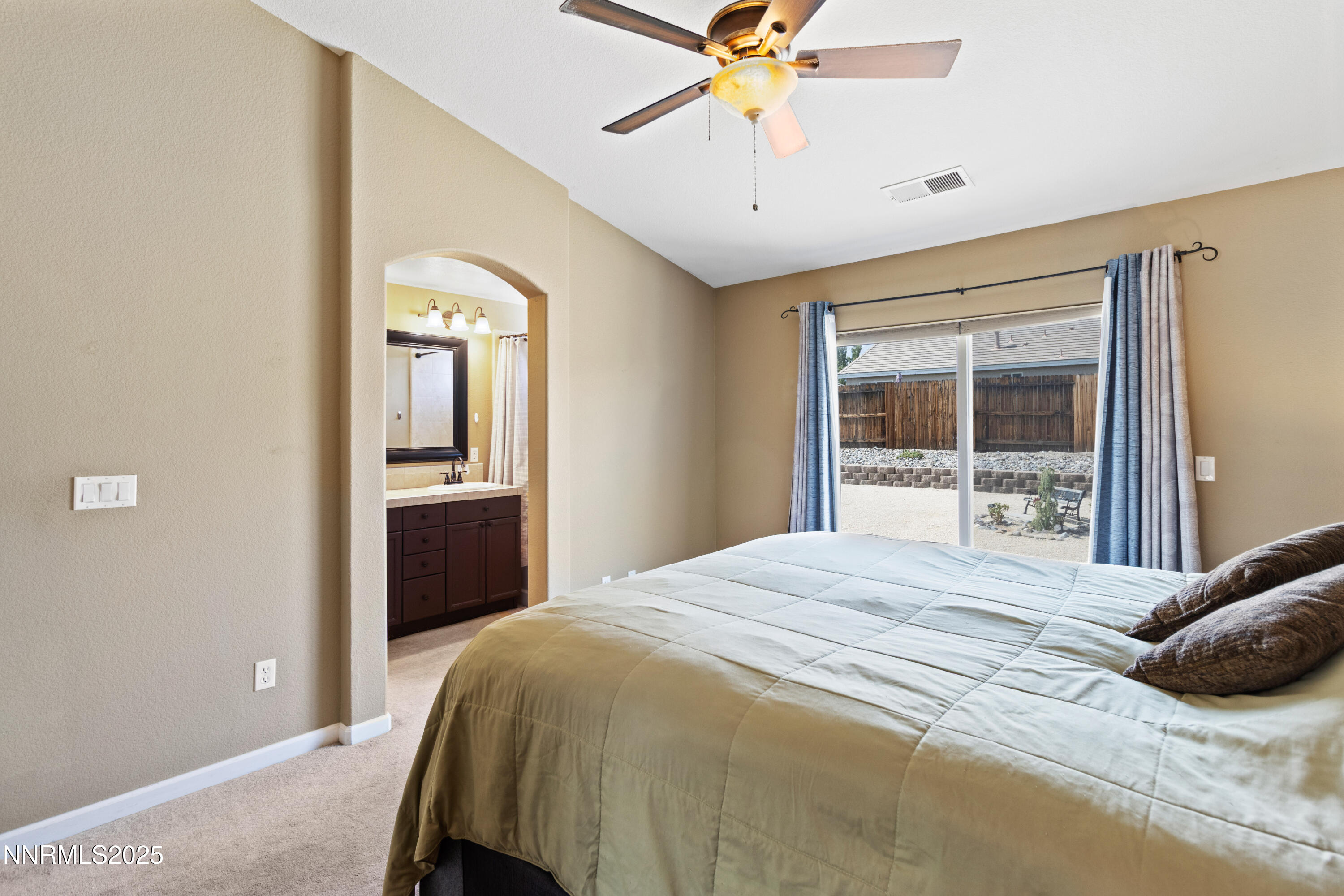 10375 Rosemount Drive Reno, NV 89521 - Photo 18 of 29 a bedroom with a bed and a chandelier