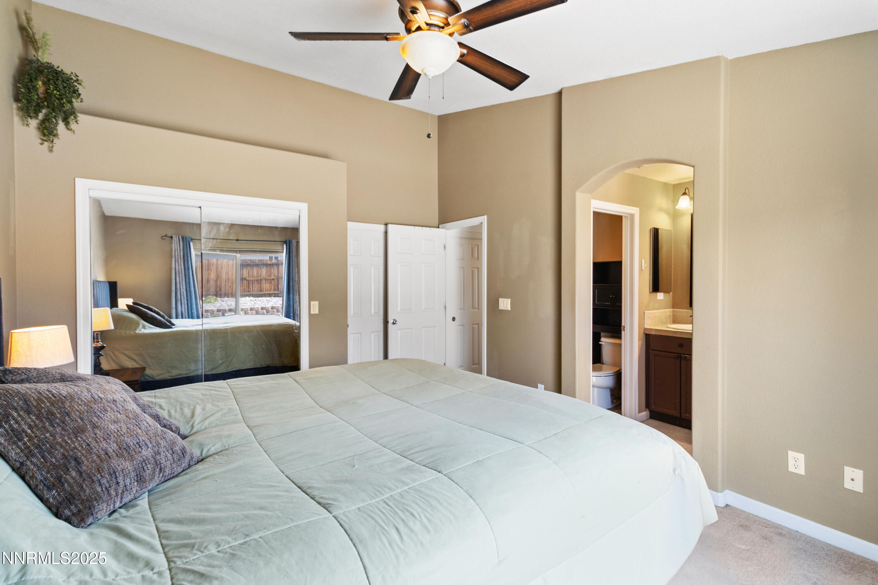 10375 Rosemount Drive Reno, NV 89521 - Photo 19 of 29 a bedroom with a bed and a chandelier