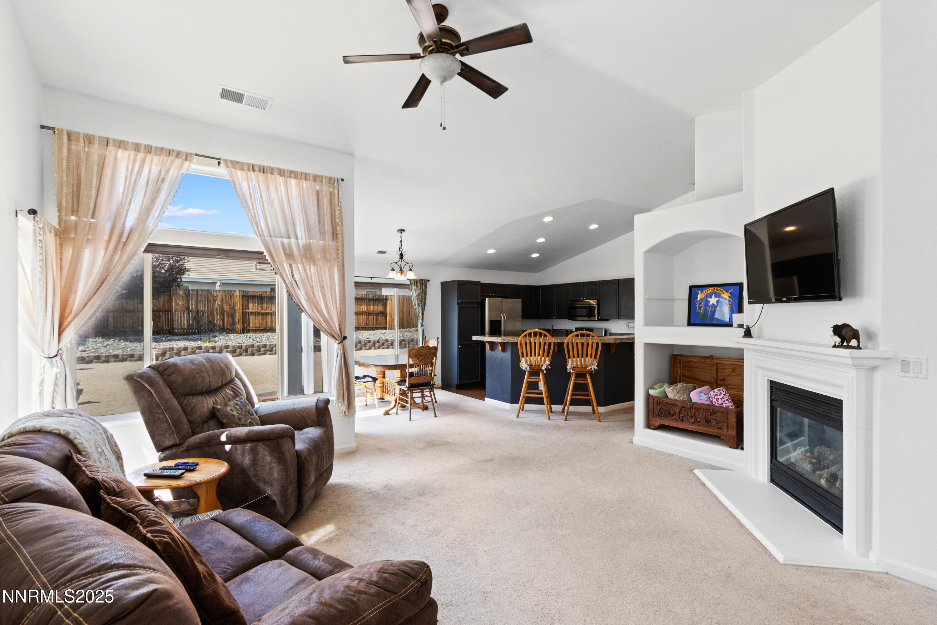 10375 Rosemount Drive Reno, NV 89521 - Photo 5 of 29 a living room with furniture a flat screen tv and a fireplace
