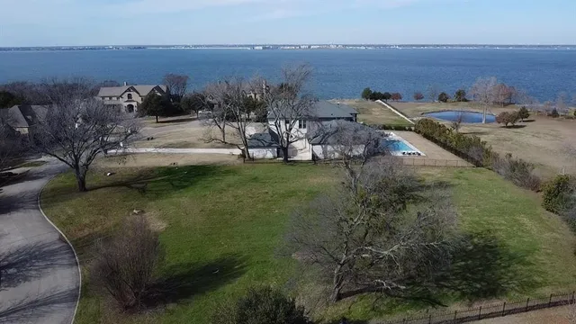 an aerial view of a house with yard and seating space