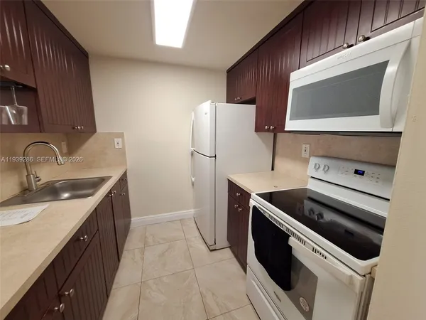 a kitchen with a sink stove and microwave