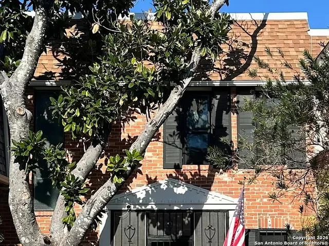 a view of house with a tree