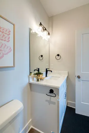 a bathroom with a sink a toilet and mirror