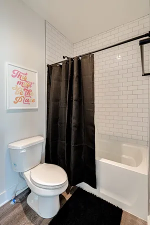 a bathroom with a toilet and a shower
