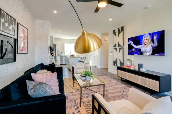 a living room with furniture and a lamp