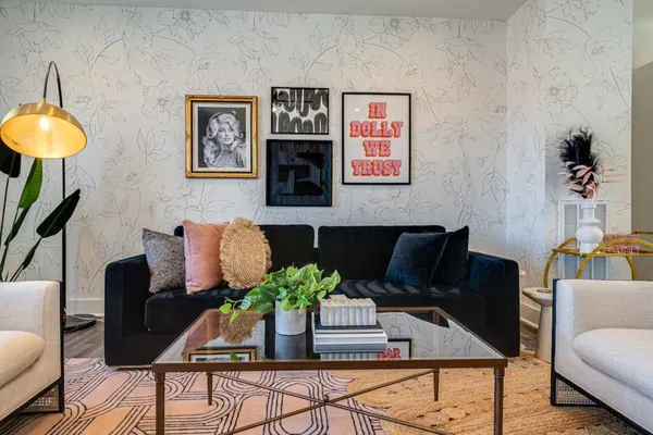 a living room with furniture and a potted plant