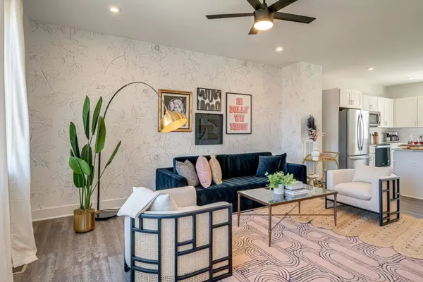 a living room with furniture and a potted plant