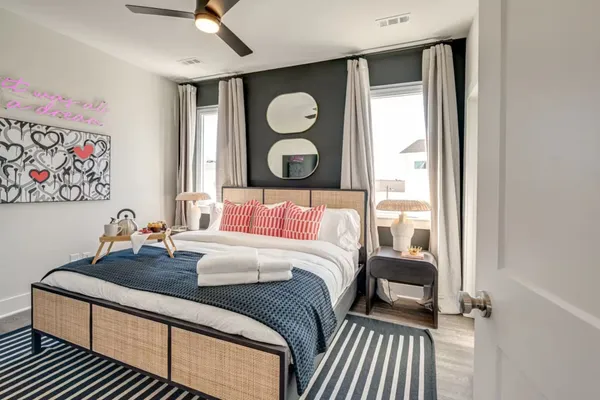 a bedroom with a bed and a painting on the wall