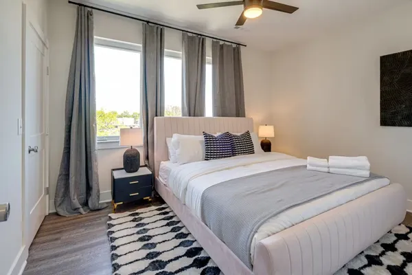 a bedroom with a bed and a chandelier