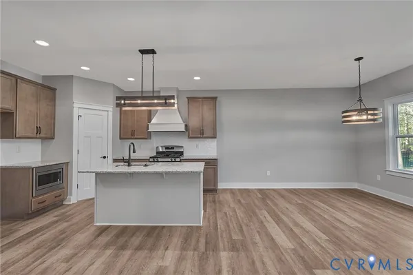 a kitchen with kitchen island a sink and a stove
