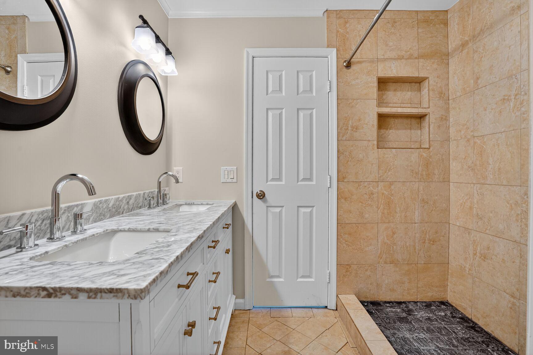 6836 Kerrywood Circle Centreville, VA 20121 - Photo 13 of 22 a bathroom with a granite countertop sink a mirror and a shower