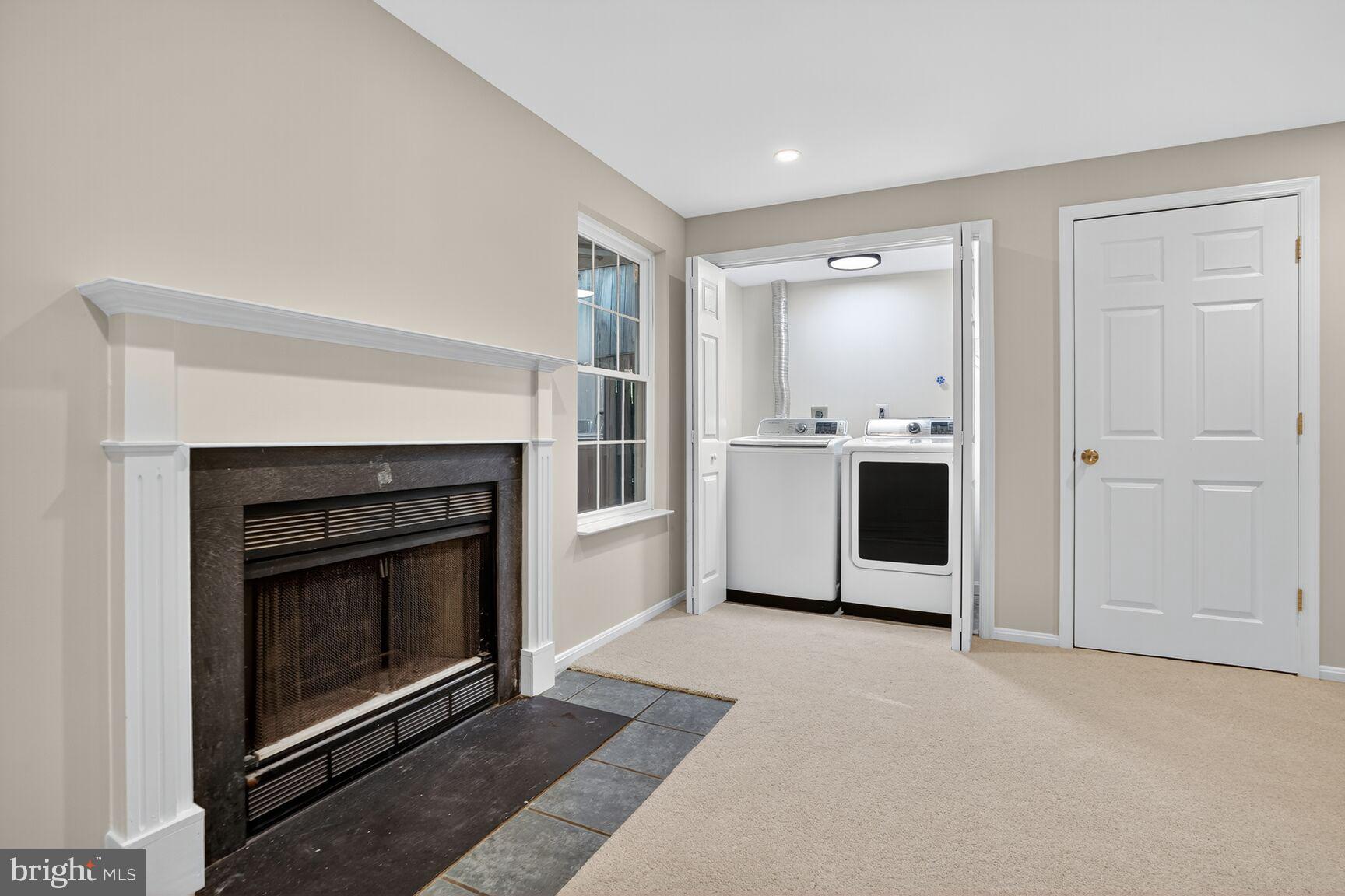 6836 Kerrywood Circle Centreville, VA 20121 - Photo 20 of 22 a living room with stainless steel appliances wooden floor and a fireplace